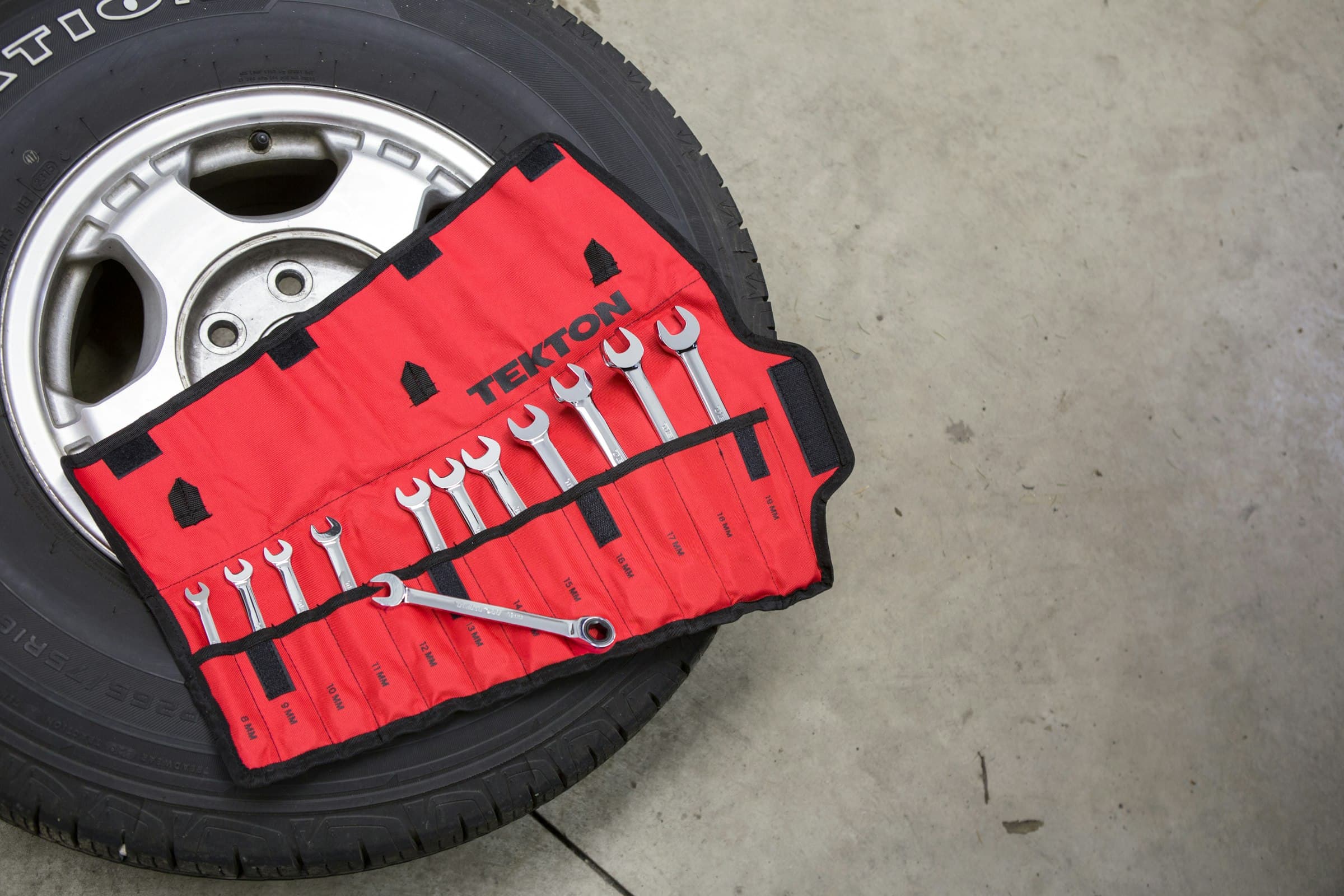 A roll of wrenches laid out on a wheel